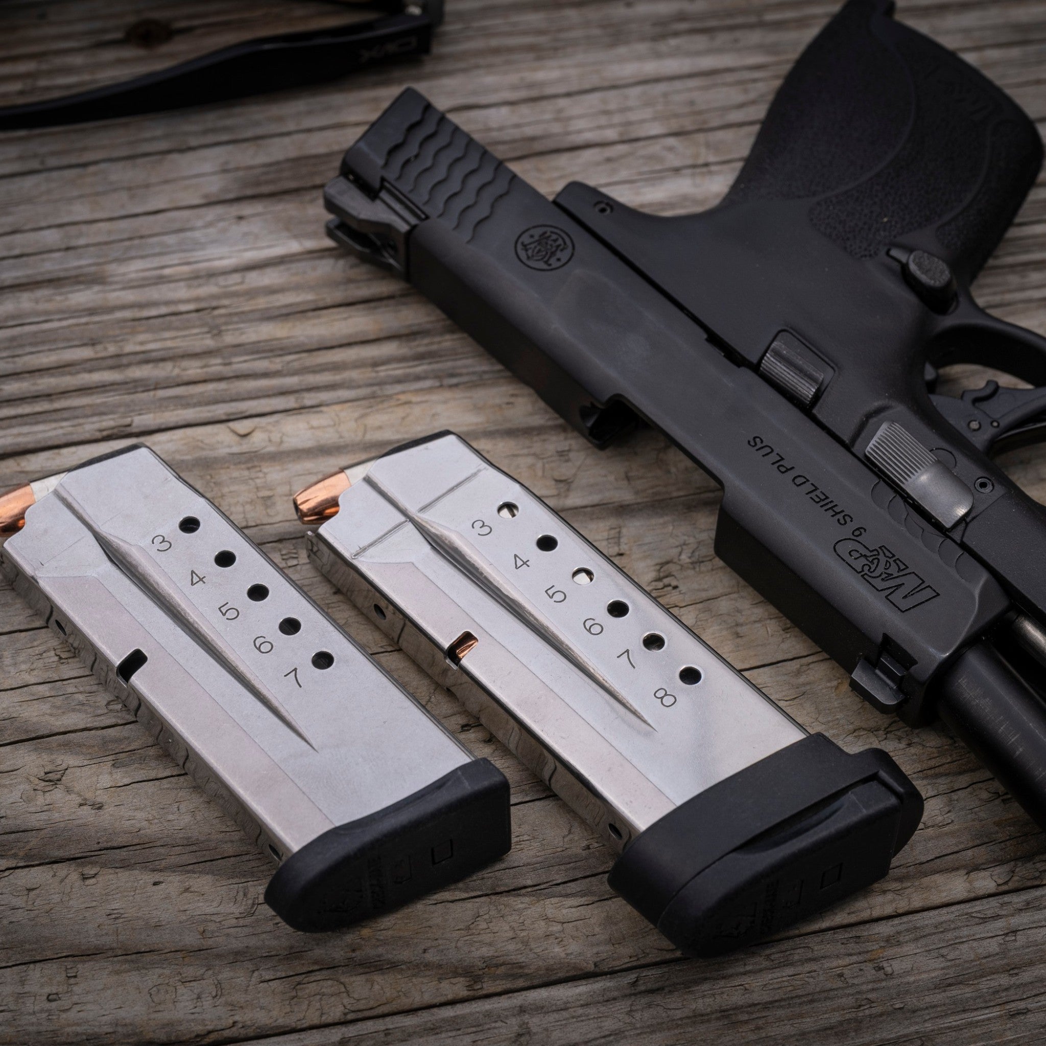 Check-Mate Mags S&W Shield 9mm magazine with stainless steel body and black base plate for reliable firearm performance.